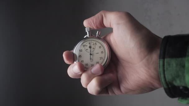 Mans Hand starting up a Stopwatch at gray background 4K, 10 BIT, 4:2:2 - Footage, Video