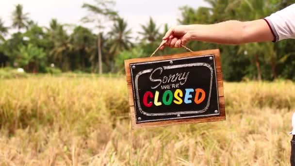 Man hands with closed sign board on a tropical nature background. Bali island. - Footage, Video