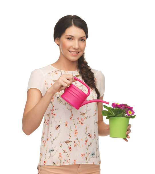 Housewife with flower in pot and watering can - Fotografie, Obrázek
