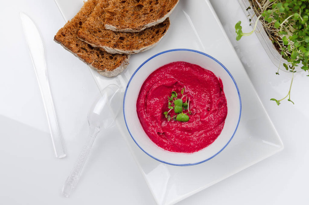 beet hummus in portions served with whole grain bread - Photo, Image