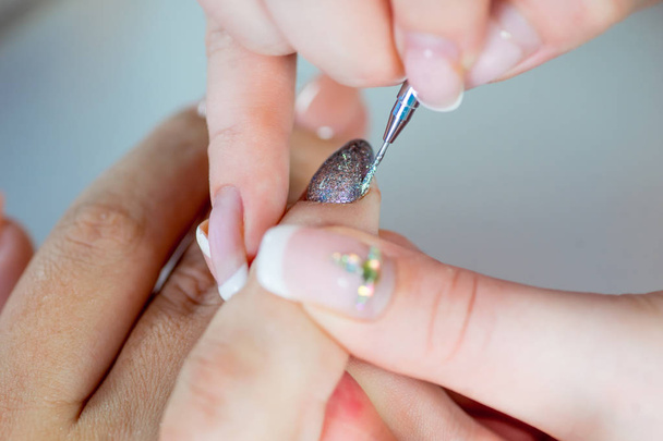 nail care and manicure in a nail salon - Foto, Imagen