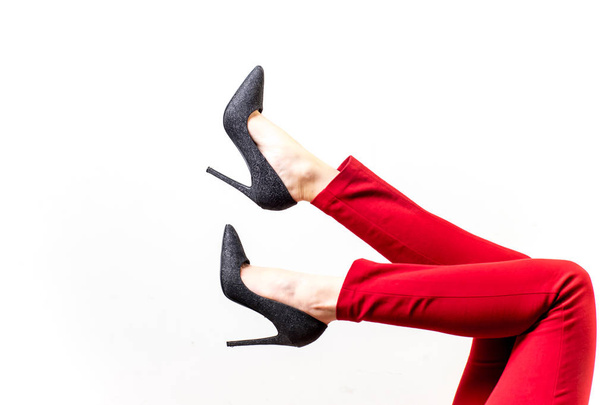 Female legs in red trousers and shoes - 写真・画像