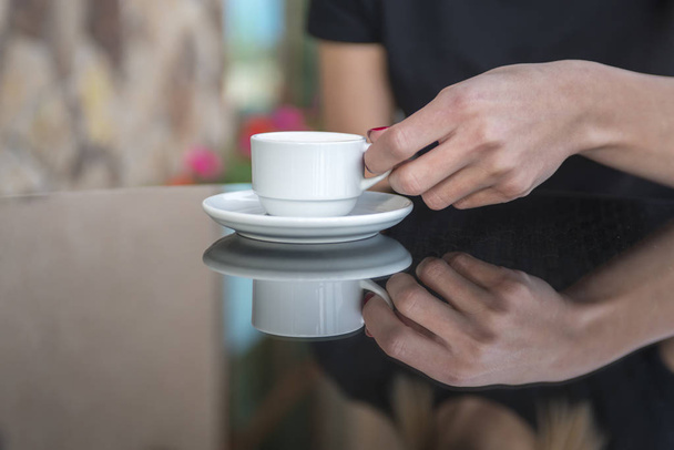 White coffee cup on wooden table in coffee shop blur interior background - Fotoğraf, Görsel