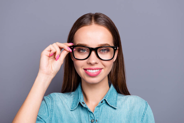 Close up portrait of self-confident adjusting cute her she young woman employee with hand on glasses wearing casual jeans shirt isolated on grey background - Фото, изображение