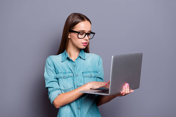Close up portrait of laptop reading sending sms to friends with impression she her woman people person wearing glasses jeans shirt outfit clothes isolated on grey background - Fotografie, Obrázek