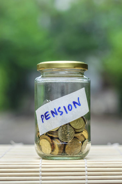 Coins in bottle with label Pension - financial concept - Photo, Image