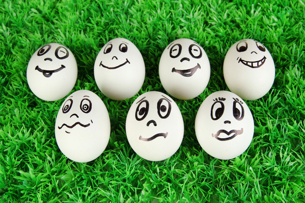 Eggs with funny faces on grass - Φωτογραφία, εικόνα