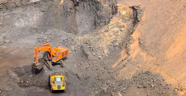Manganese Mining and Excavator digging and loading ore rocks on a Manganese mine - Photo, Image