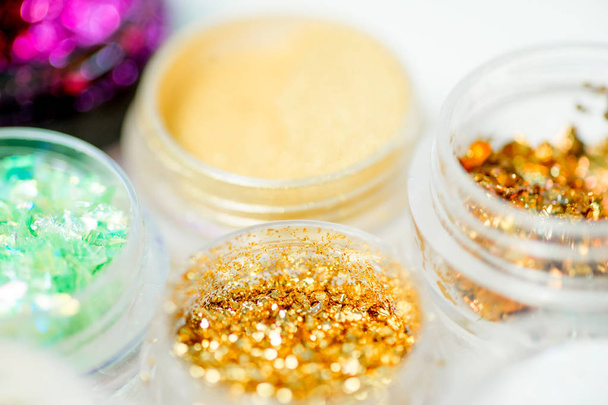 Collection of nail glitters of different colors in jars - Foto, Imagen