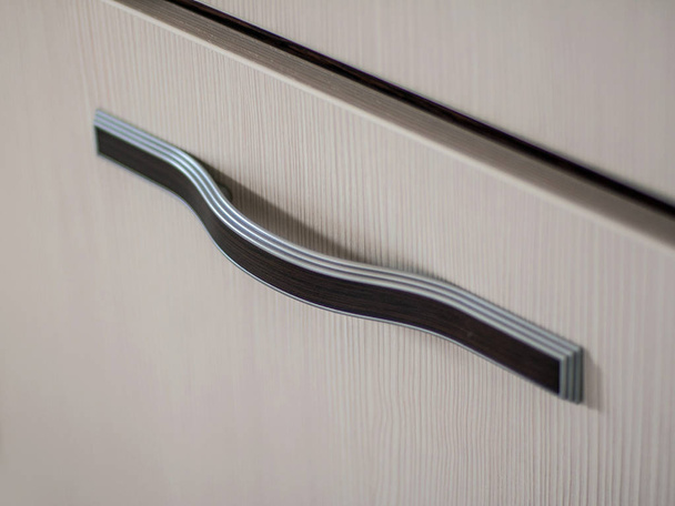 Beautiful and diverse subject. Beautiful curved metal and wood handle for furniture. - Valokuva, kuva
