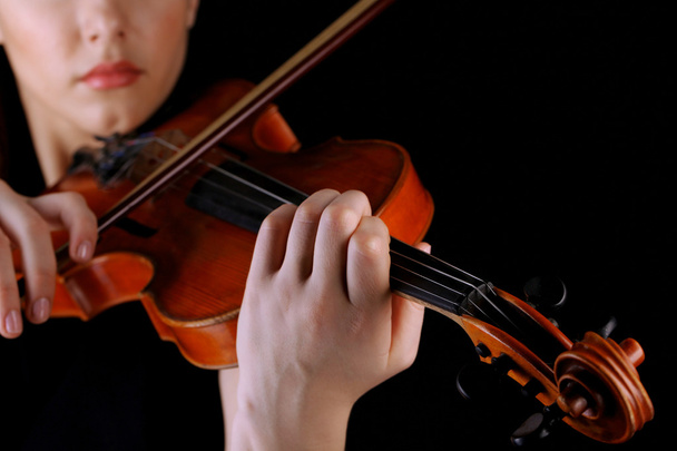 Musician playing violin on black background - Photo, image