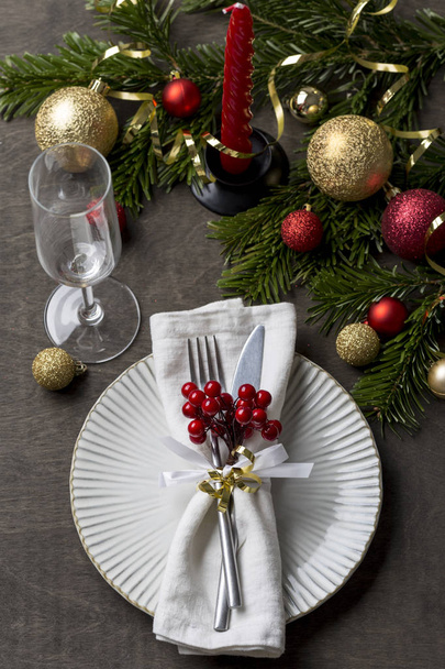 Holiday Christmas place setting with fork and knife, glass, ribbon, berries and christmas decorations, Christmas background - Foto, Imagen