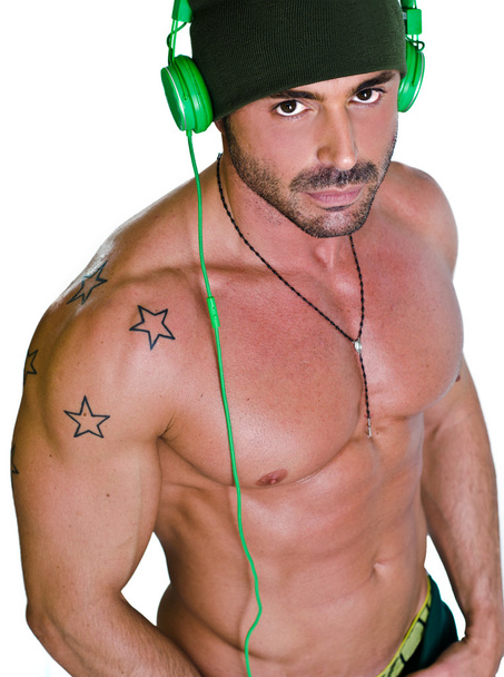 Muscular tanned shirtless man with headphones - Foto, immagini