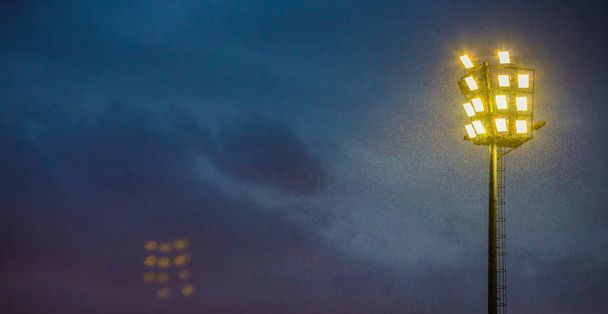Bright sports stadium lights on a cloudy evening in Johannesburg South Africa - Photo, Image