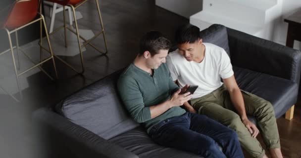 Overhead shot of male friends looking at smartphone together - Video
