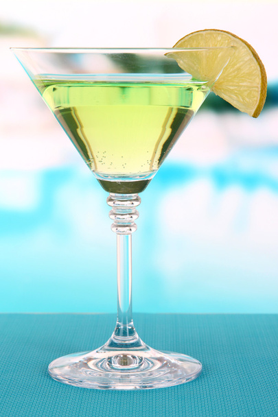 Green cocktail with lime on table on bright background - Foto, afbeelding