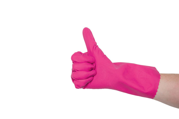 Pink glove for cleaning on a female hand shows thumb up. The concept of cleanliness. - 写真・画像