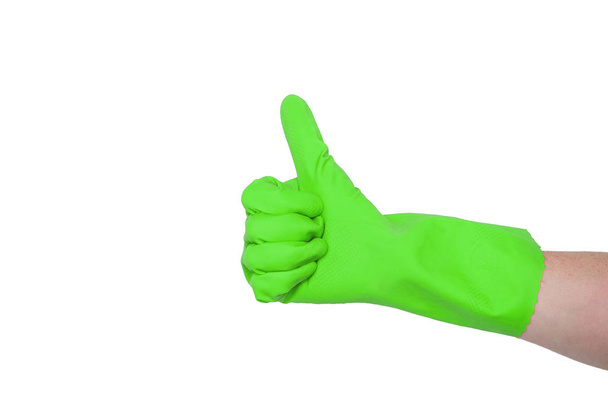 Green glove for cleaning on a female hand shows thumb up. The concept of cleanliness. - Foto, afbeelding