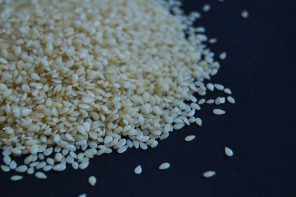 sesame seeds on black background. raw, healthy, vegan food. - Photo, Image
