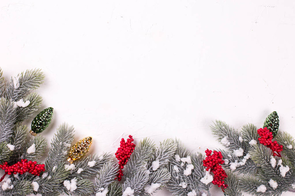 close up view of golden and green pine cones and fir tree branches on white background  - Foto, afbeelding