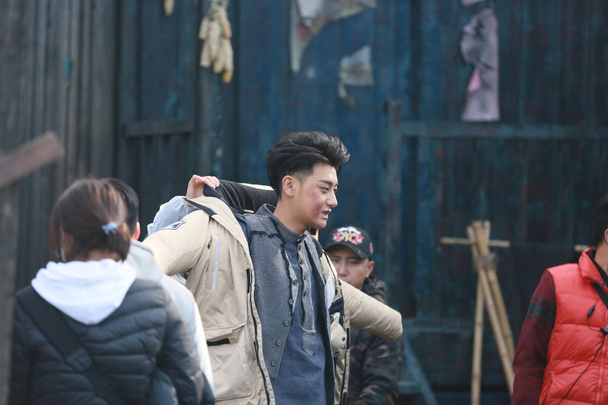 Chinese actor Huang Zitao, better known as Z.Tao, is pictured during a filming session on set of his new TV series "The Files of Teenagers in the Concession" at Hengdian World Studios in Hengdian town, Dongyang city, east China's Zhejiang province, 2 - Foto, immagini
