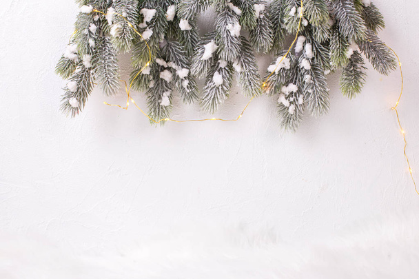 top view of fit tree branches and christmas decorations on white background - Foto, afbeelding