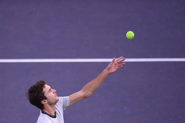 Gilles Simon of France serves against Marco Cecchinato of Italy in their first round match of the men's singles during the Rolex Shanghai Masters 2018 tennis tournament in Shanghai, China, 8 October 2018 - Photo, image