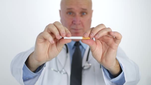 Doctor Disagree Smoking Habit Showing and Breaking a Cigarette with His Hands - Filmmaterial, Video