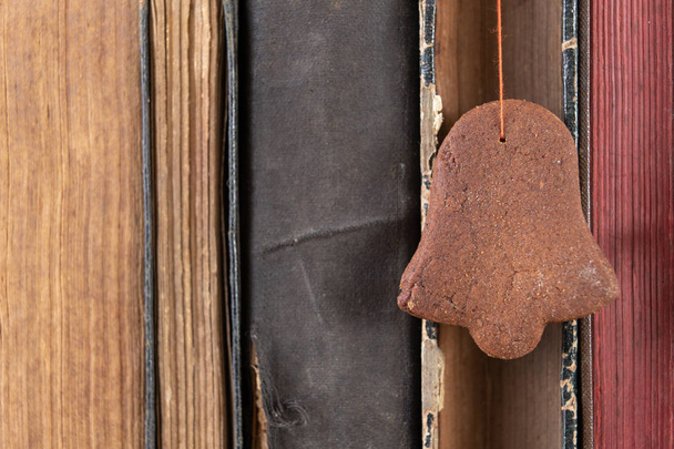 Tasty gingerbread and book loss. Dessert on a wooden table in the cabinet. Light background. - Foto, imagen