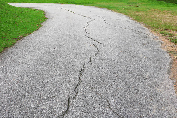 asphalt road cracked. street in public park - Photo, Image