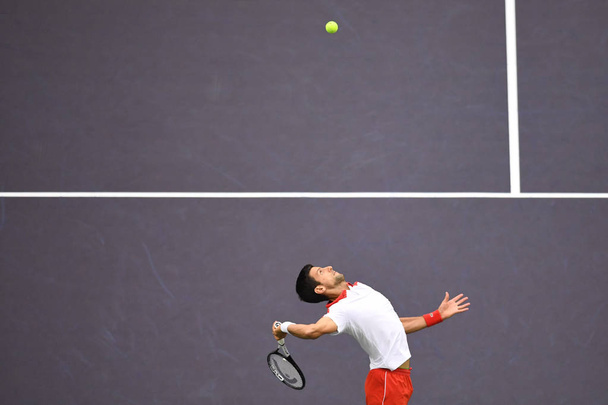 Novak Djokovic of Serbia serves against Borna Coric of Croatia in their men's singles final match during the Rolex Shanghai Masters tennis tournament in Shanghai, China, 14 October 2018. - Fotoğraf, Görsel