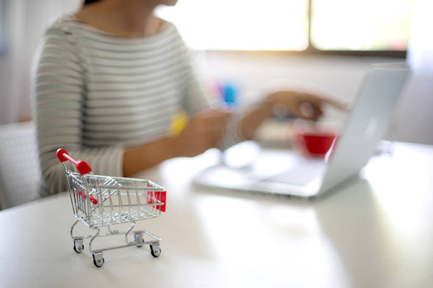 woman sit at computer table work about shopping online sale and buy order - 写真・画像