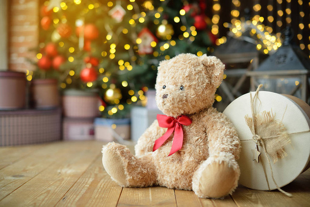 Teddy bears siting under the christmas tree with presents - Фото, изображение