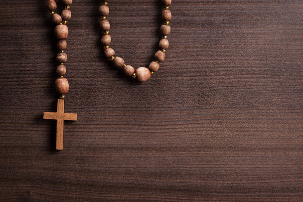 Cross over brown wooden background - Foto, Imagem