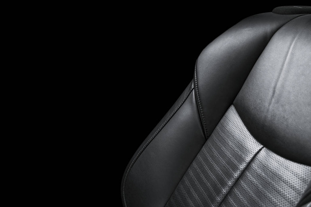 Black leather interior of the luxury modern car. Perforated Leather comfortable seats with yellow stitching isolated on black background. Modern car interior details. Car detailing - Foto, imagen