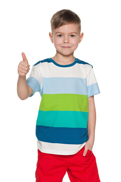 Cute young boy holds his thumb up - Фото, зображення
