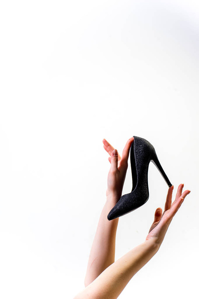 Female hands holding fashionable high heel shoes - Φωτογραφία, εικόνα