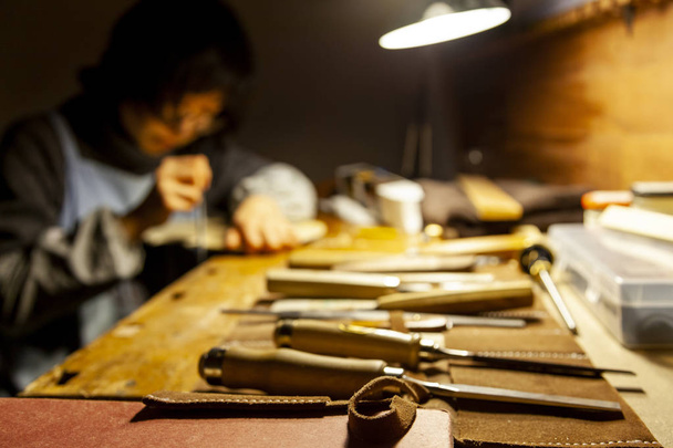 female artisan violinmaker while viewing a new violin in the laboratory - 写真・画像
