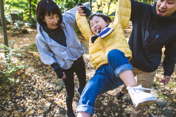 Happy and playful japanese family in a park in Tokyo - Фото, зображення