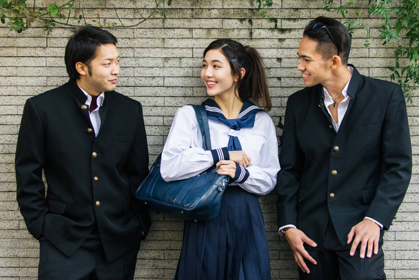 Yung japanese students with school uniform bonding outdoors - Group of asian teenagers having fun - Φωτογραφία, εικόνα
