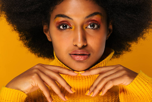 Portrait of pretty afro american woman in a studio for a beauty session - Beautiful girl posing on colored background - Foto, afbeelding