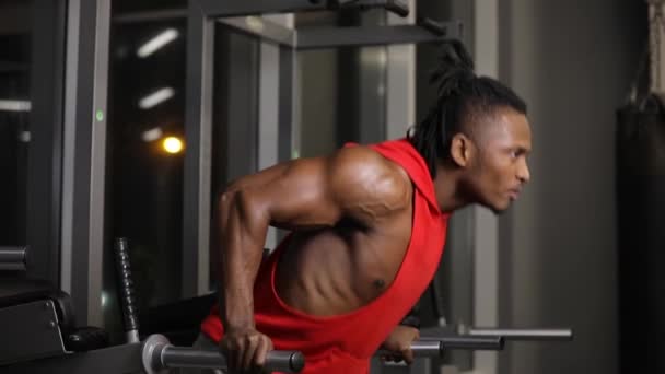 African american man push ups in gym on parallel bars - Video
