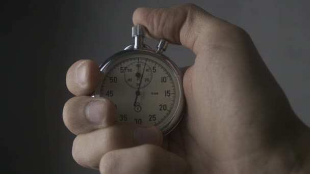Close up van een persoon een stopwatch op grijze achtergrond opstarten. 4k, 10 Bit, 4:2:2 - Video