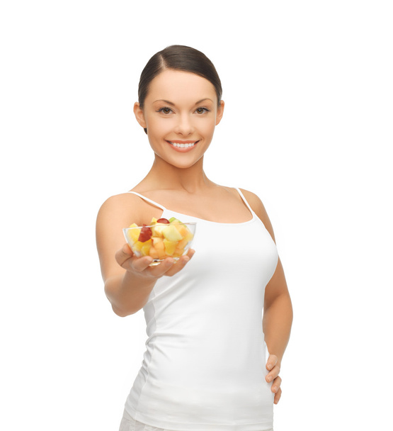 Healthy woman holding bowl with fruit salad - Фото, зображення