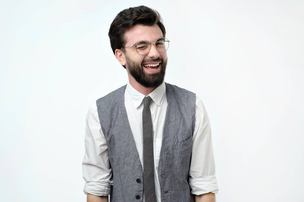Красивий іспанський чоловік в офісному одязі підморгнув і посміхнувся
 - Фото, зображення