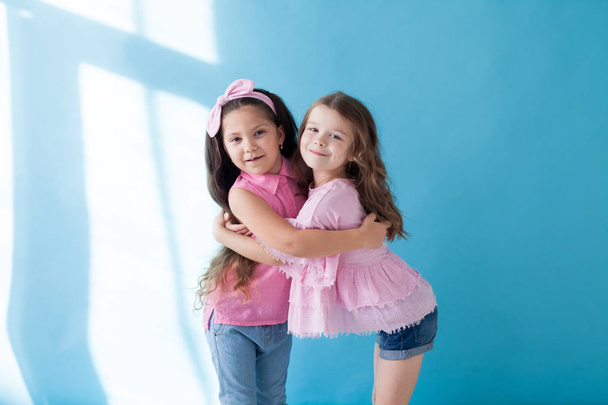 two beautiful small girls girlfriend sister in pink clothes - Photo, Image