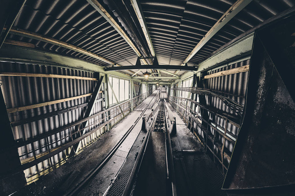 Old abandoned industrial mine passage, color toning applied. - 写真・画像