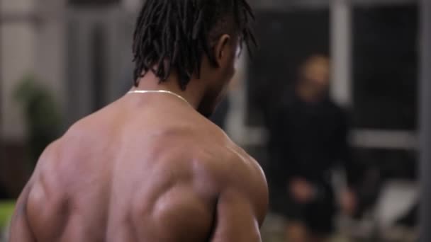 African american man pumping muscles with dumbbells in gym - Imágenes, Vídeo