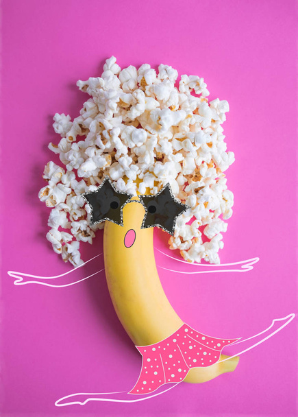Conceptual photo of a banana on a pink background. Banana dancer. - Fotoğraf, Görsel