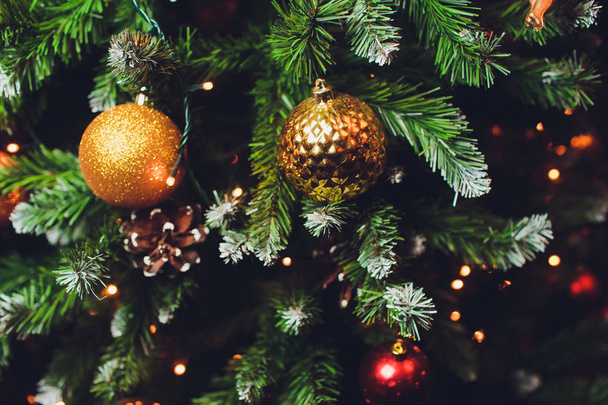 gold and silver Christmas decorations on the tree. - Φωτογραφία, εικόνα